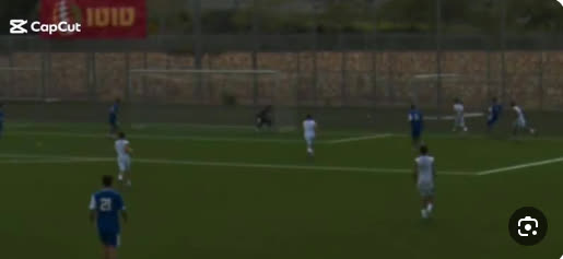 A distant, blurry phone recording of a match with an editing-app watermark